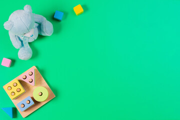 Baby kid toys on light green background. Top view, flat lay