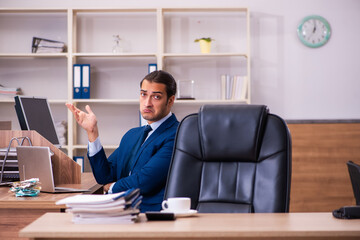Young male employee working in the office
