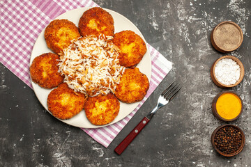 top view fried cutlets with cooked rice and seasonings on dark background rissole dish meat
