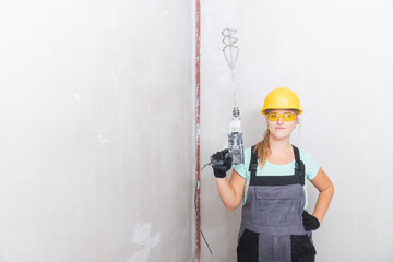 Woman worker makes repairs in apartment, dressed in uniform. Builder Holds mixer for mixing plaster mortar