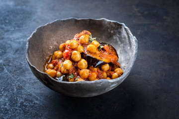 Modern style slow cooked Lebanese vegetarian eggplant stew maghmour served with chickpeas as...