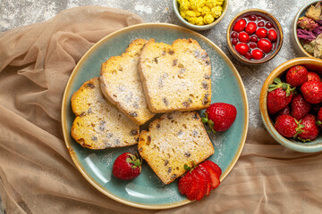 top view yummy cake slices with fresh strawberries on light floor fruits sweet pie