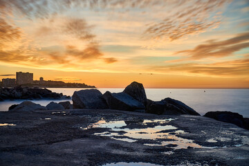beautiful sunrise on the beach with rocks