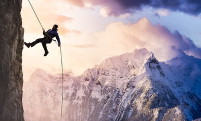 Epic Adventurous Extreme Sport Composite of Rock Climbing Man Rappelling from a Cliff. Mountain...