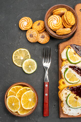 top view cake slices with choco bars and cookies on the dark background cake sweet pie dessert