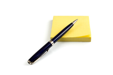 Yellow sticky note pad with pen, isolated on white background. Picture taken in studio with soft-box.