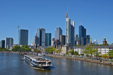 Fototapeta na wymiar A boat on the river Main in the background the skyline of Frankfurt on Main, in Germany