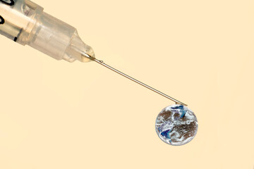 Close-up medical syringe with a vaccine. COVID-19 vaccine. Healthcare And Medical concept. "Elements of this image furnished by NASA"