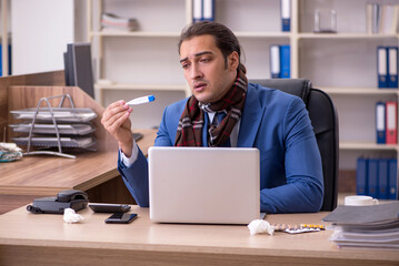 Young sick businessman employee suffering at workplace