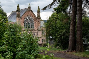 Fototapeta na wymiar Building of Ness Bank Church in Inverness, Scotland hidden behind bush