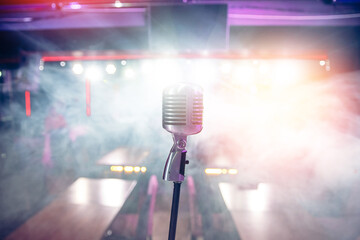 Close-up old retro vintage microphone on blurred stand up smoke background concert