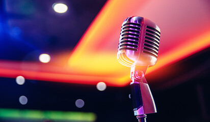 Close-up retro vintage microphone on blurred stand up background, concert in nightclub