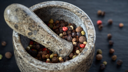 Stone Mortar and pestle with pepper seeds