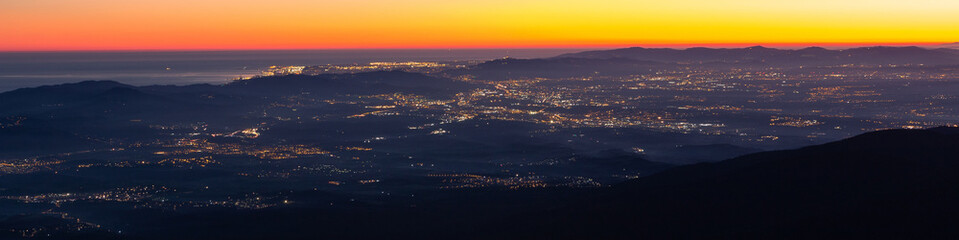 Barcelona aerial view at dusk with the lights of the city in the away. Beautiful panoramic cityscape of the city of Barcelona from Montseny, Turo de l'Home, Catalunya-Catalonia.