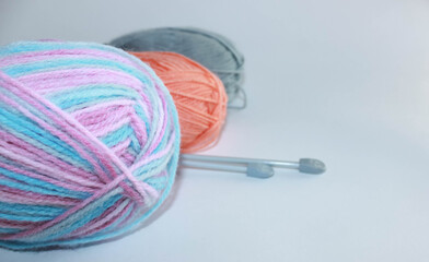 Multicolored skeins of yarn on white background