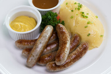 Six Bavarian grilled Nuremberg sausages served with potato mash, dark beer jus and mustard