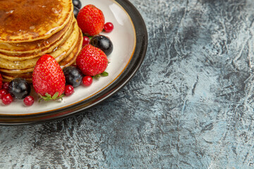 front view yummy pancakes with fruits and honey on light floor breakfast sweet fruit