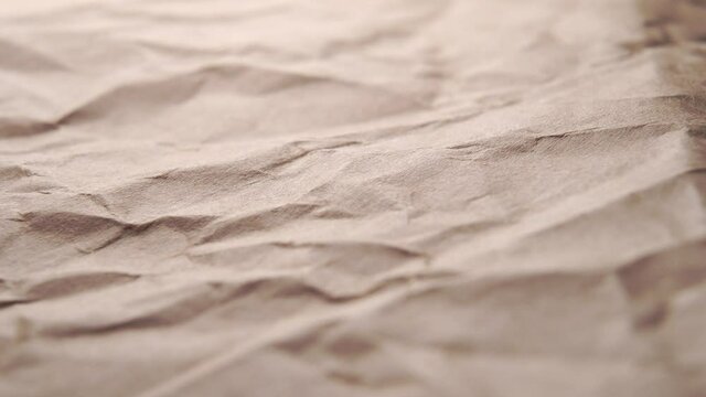 Crumpled craft wrapping paper, wrinkled texture. Dolly shot