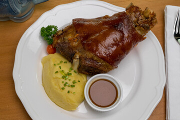 Bavarian grilled pork knuckle served with potato mash and dark beer sauce