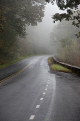 Mountain road into the fog