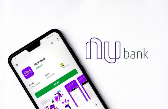 Stone, Staffordshire / UK - November 17, 2019: Nubank logo on a brochure and the cell phone with Nubank app on the screen.