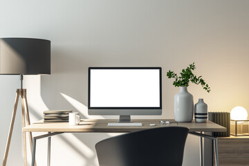 Clean office workplace with white glowing computer screen