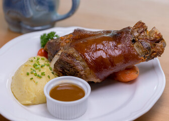 Bavarian grilled pork knuckle served with potato mash and dark beer sauce