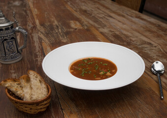 Hearty beef goulash soup served with toasted bread