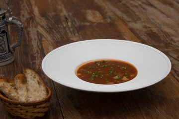 Hearty beef goulash soup served with toasted bread