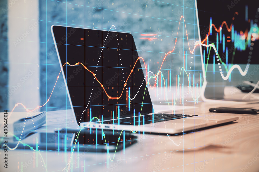 Poster Laptop computer on desktop with stock charts