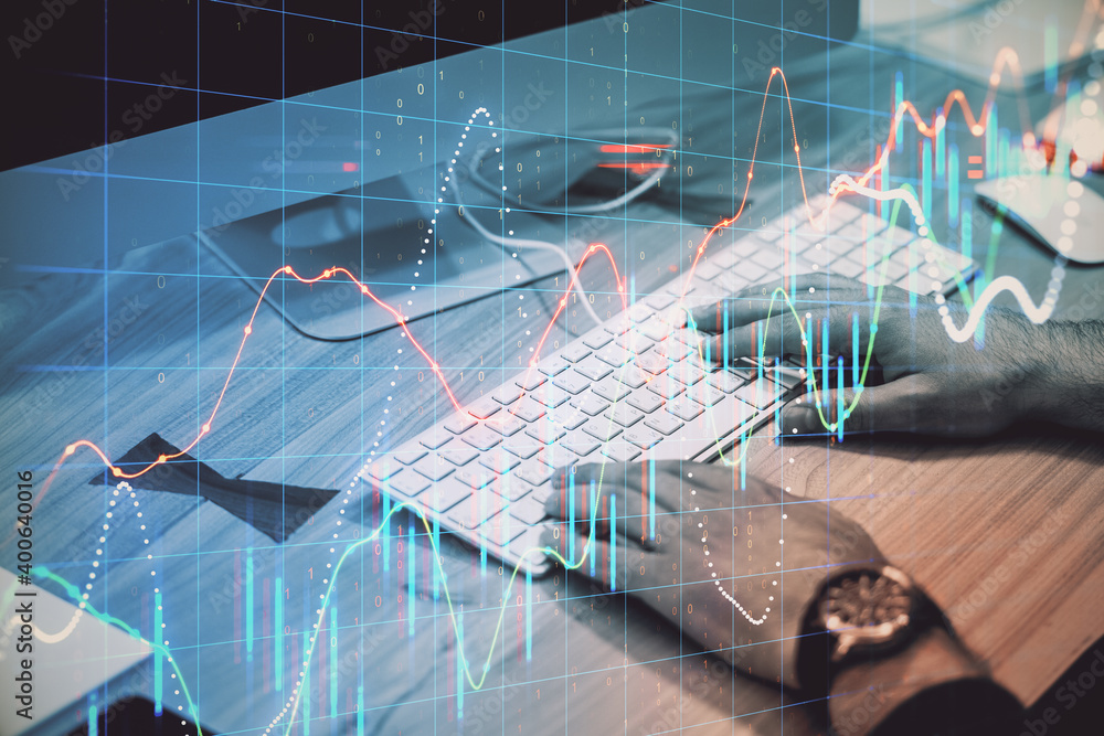 Poster Hand typing on keyboard computer with stock charts interface.