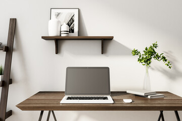 Modern designer workplace with laptop on wooden table.