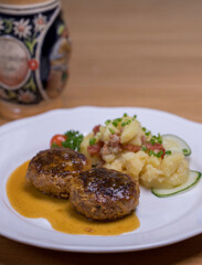 Pan-fried meatballs served with Bavarian potato cucumber salad