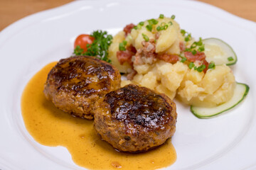 Pan-fried meatballs served with Bavarian potato cucumber salad