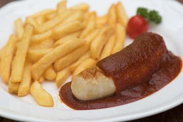 Currywurst, Berlin style grilled sausage served with ketchup and curry sauce