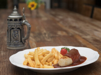 Currywurst, Berlin style grilled sausage served with ketchup and curry sauce