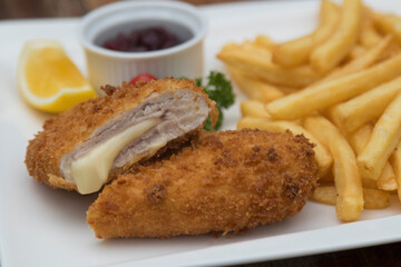 Pork Cordon Bleu served with French fries and Cranberrry Sauce