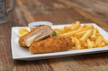 Pork Cordon Bleu served with French fries and Cranberrry Sauce