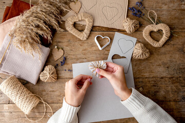 Zero waste Valentine's Day concept and mock up. Female hands drow stencil heart. Top view or...