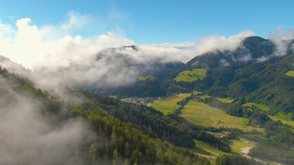 DRONE: Spectacular aerial shot of an alpine town surrounded by the Julian Alps.