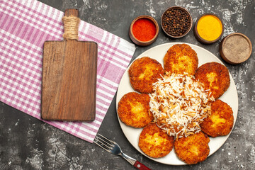 top view tasty fried cutlets with rice and seasonings on dark background food meat rissole