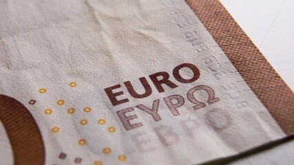 EURO sign on Fifty Euro banknote macro shot. Eurocurrency concept. Play light
