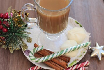coffee with milk. candy and cinnamon on plate