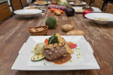 Chargrilled beef tenderloin with mixed vegetables, potato gratin mushroom sauce