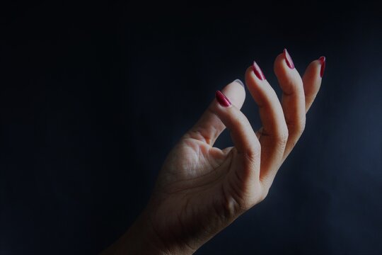 Woman hand in the dark. stock photo 