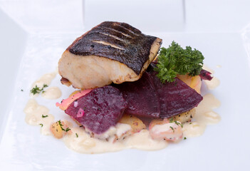 Pan-fried black cod on sautéed beetroot and potatoes with horseradish cream 