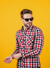 Obraz premium young handsome man in checkered shirt and sunglasses has bristle on face, casual style