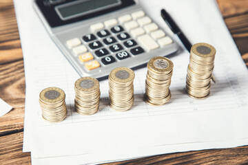 coins and calculator on document