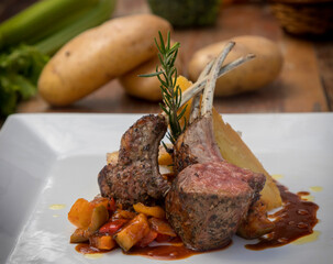 Grilled Australian lamb rack on ratatouille with potato gratin and Madeira jus