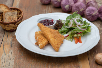 Baked feta cheese served with mixed salad and cranberry jam